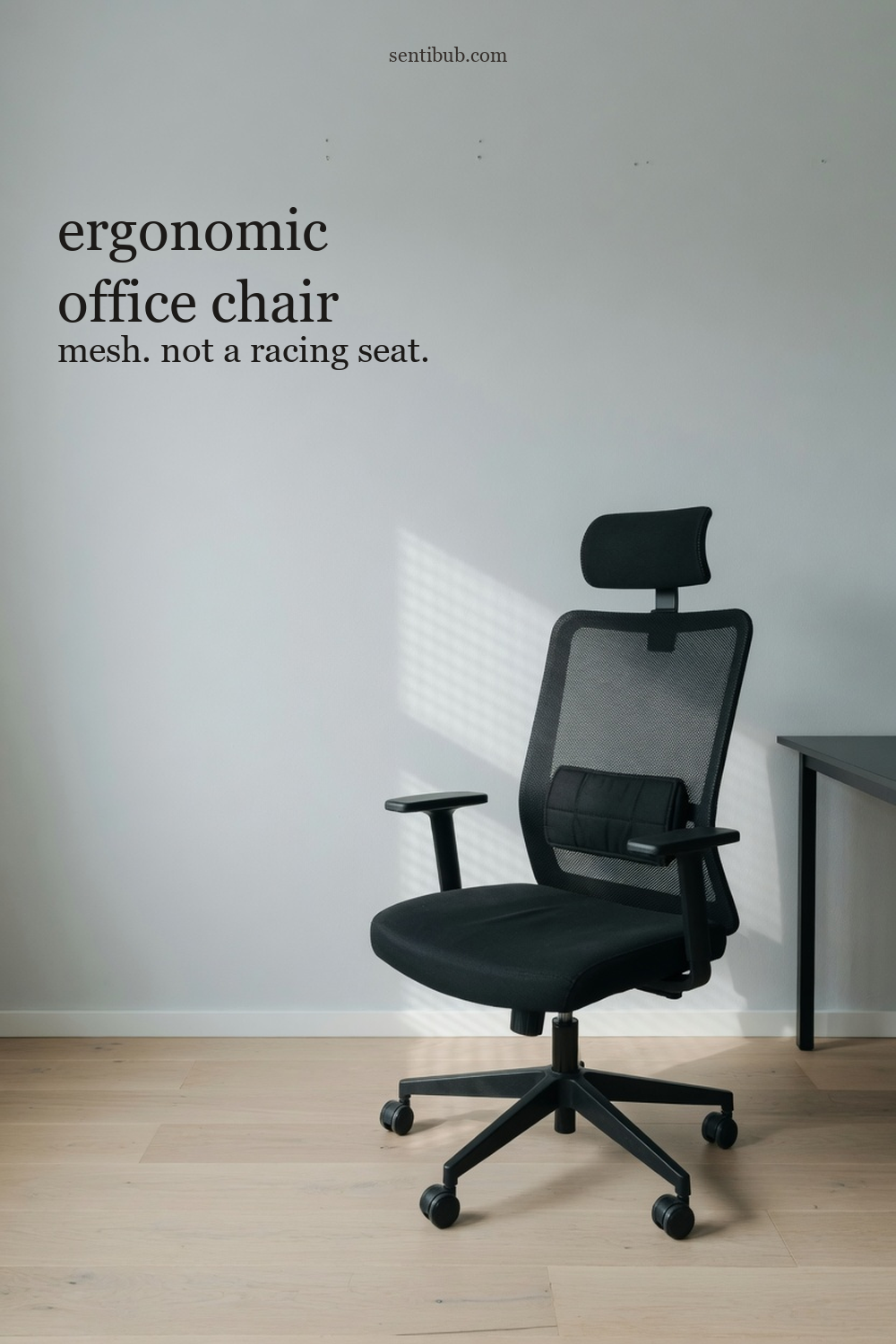 ergonomic office chair, black mesh with a headrest and a lumbar cushion, beside a desk