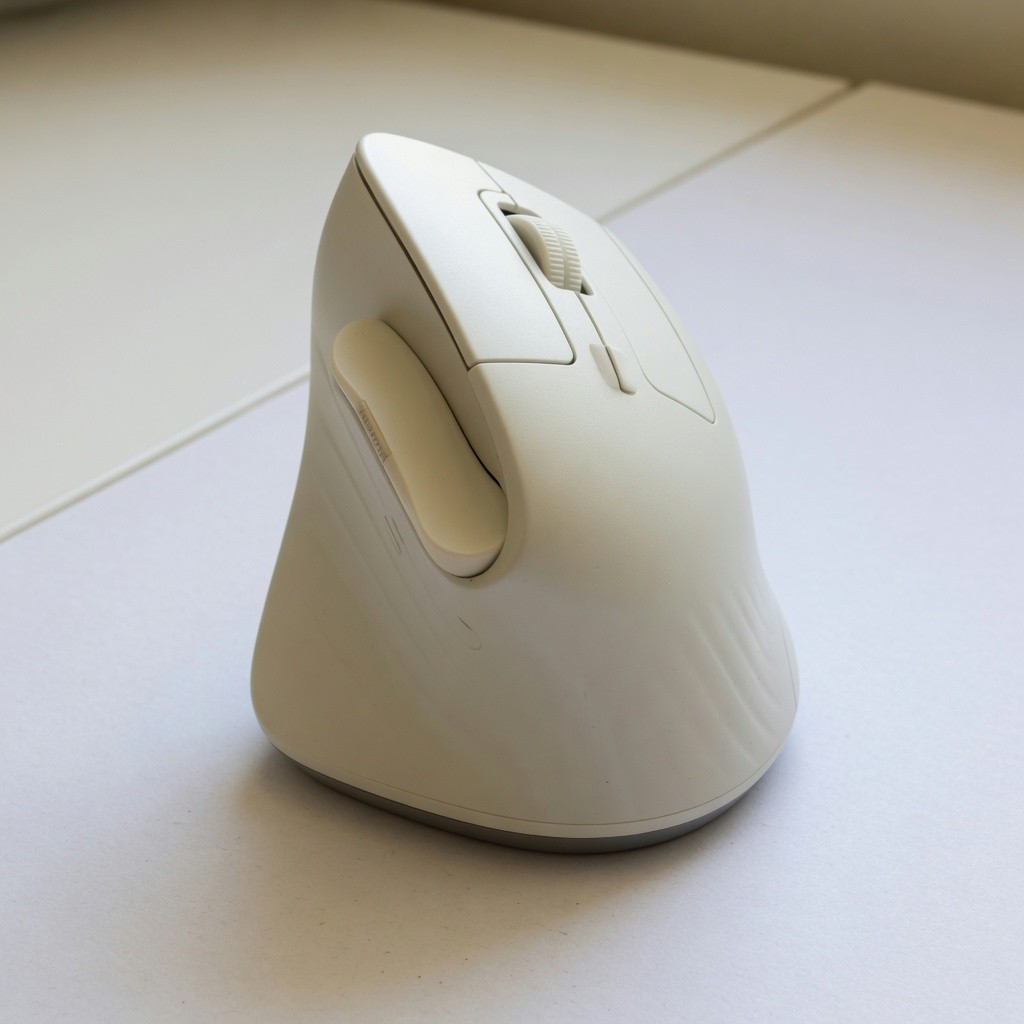 logitech lift vertical mouse, off-white, right-handed, sitting upright on a desk